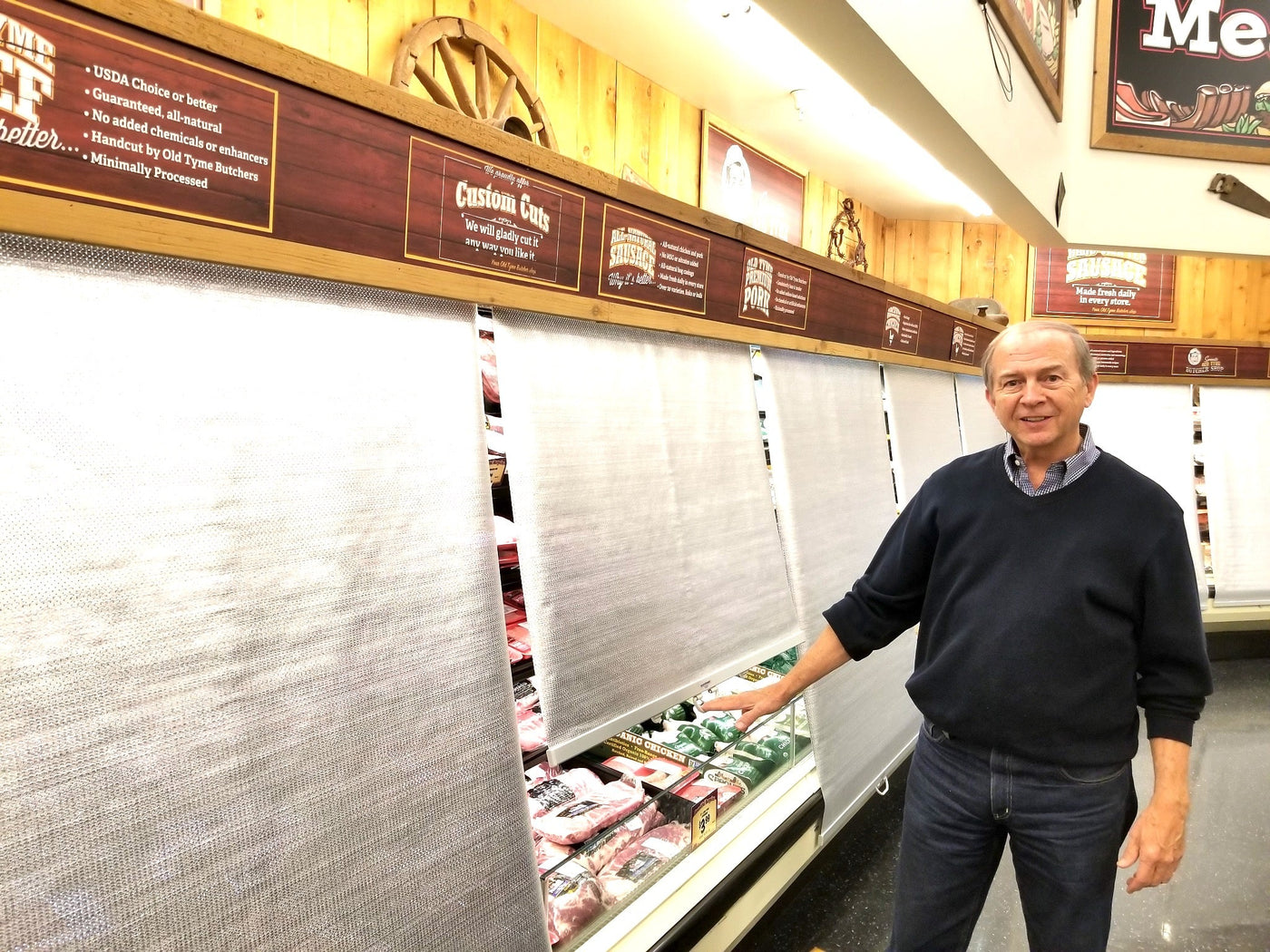 Econofrost night covers pulled down over open meat cases after closing