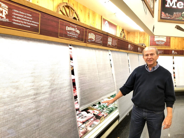 Econofrost night covers pulled down over open meat cases after closing